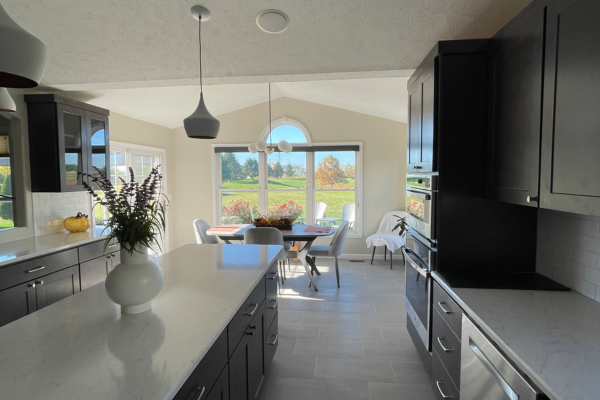 Kitchen remodel with dark shaker cabinets, quartz island, and vaulted ceiling by C-U Under Construction in Champaign, IL