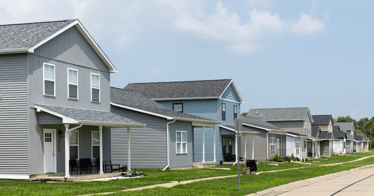 Newly built residential neighborhood with row of two-story homes and vinyl siding